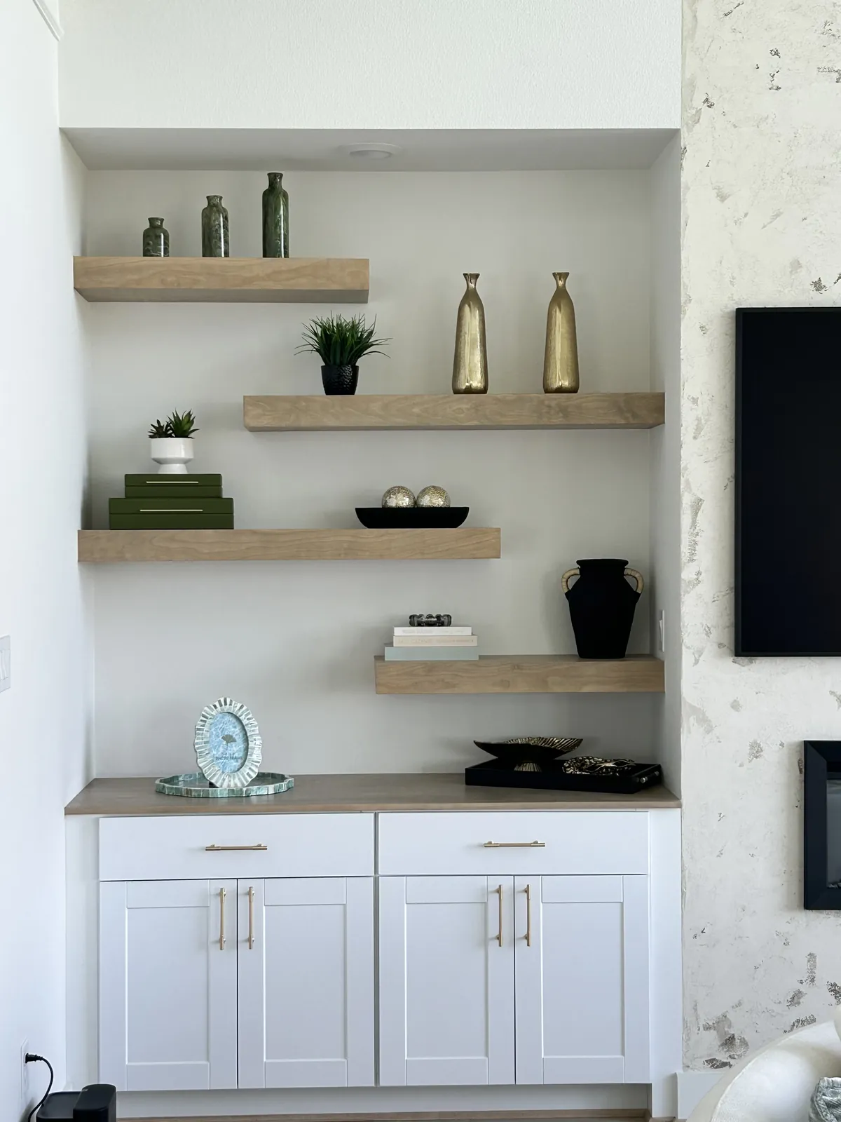 Built-in cabinets with staggered floating shelves.